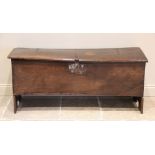 A 17th century oak six plank coffer, the rectangular hinged top with a channelled front edge,