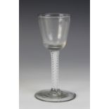 A round funnel bowl wine glass, the double series opaque twist stem terminating in a wide foot,