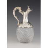 A French cut glass silver mounted liquor jug, star cut base and fluted body, silver mount with