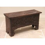 A 17th century style oak coffer bach, late 19th/early 20th century, profusely carved with lozenge