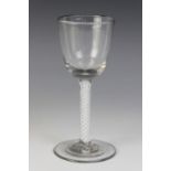 A round funnel bowl wine glass, the double series opaque twist stem terminating in a wide foot,