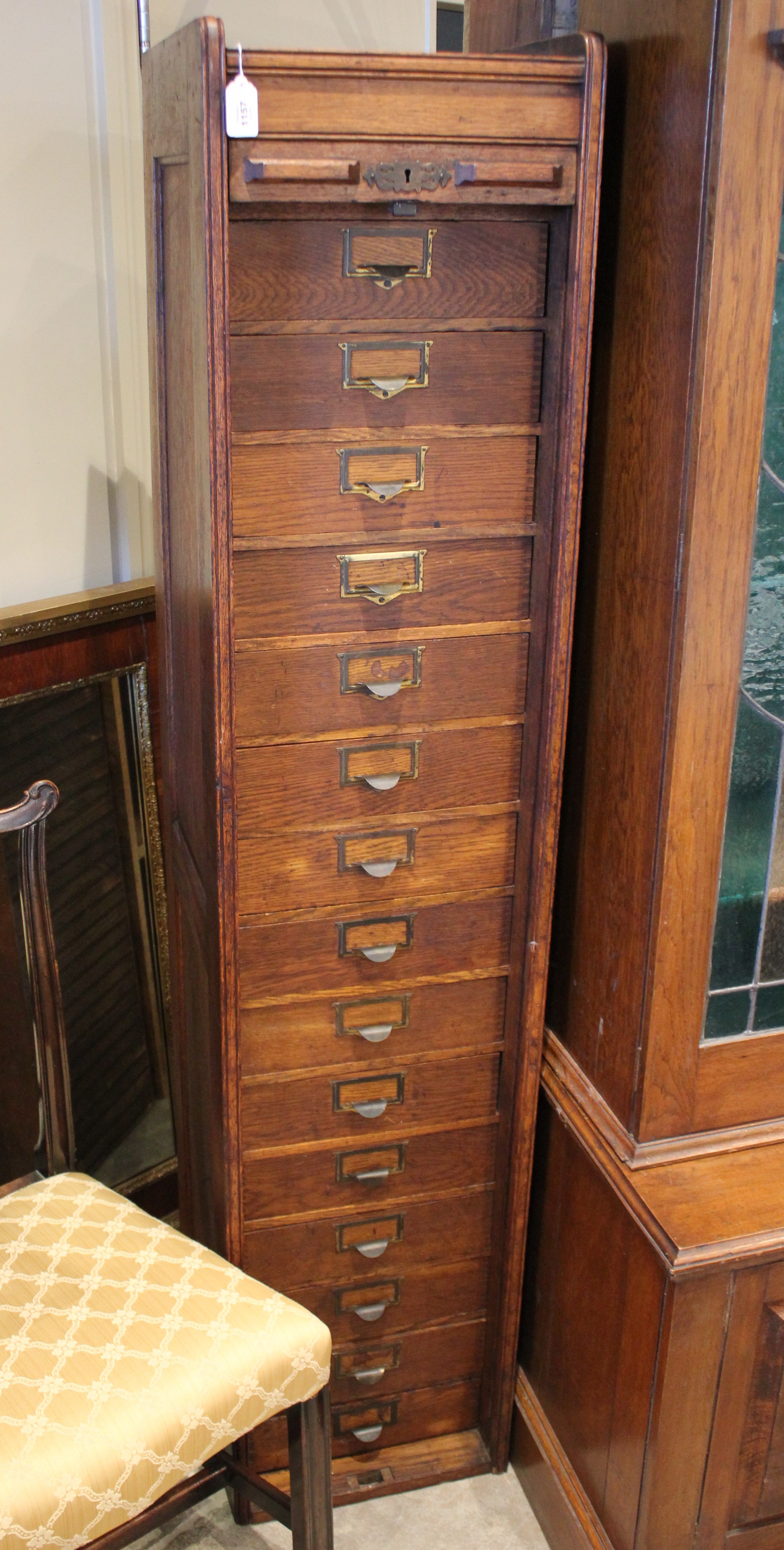 An early 20th century oak tambour front cabinet, of tall rectangular form with panelled sides, the - Bild 3 aus 8