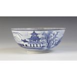 A Chinese porcelain blue and white bowl, Kangxi mark, 19th century, externally decorated with a