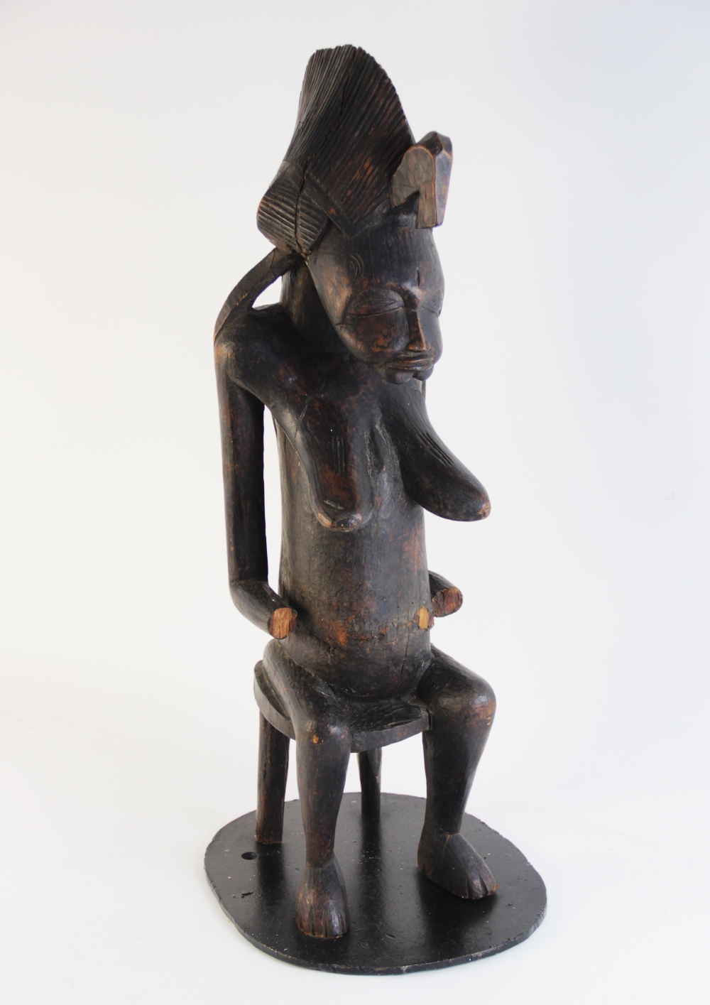 A Central African tribal fertility carving (possibly Congolese), modelled as a woman in tribal