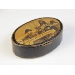 An early 19th century ebonised snuff box, of oval form with hinged cover, the cover decorated with