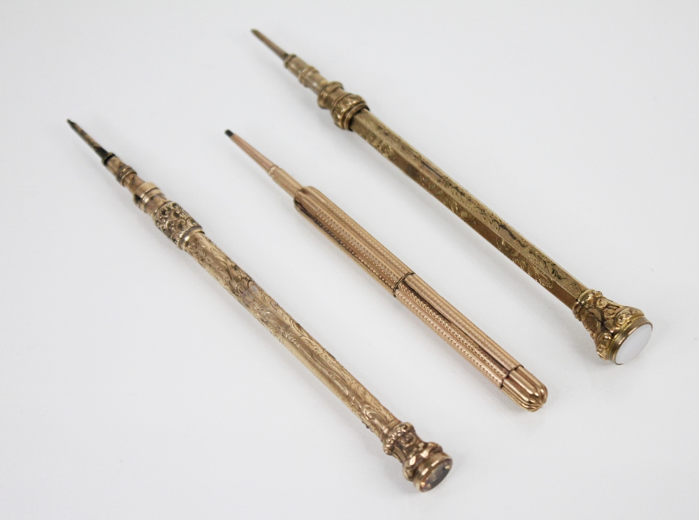 A Victorian gold coloured mechanical pencil, of cylindrical form with engraved decoration, citrine