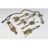 Six assorted Victorian brass skirt lifters, including a butterfly example marked ?March 19th 1877,