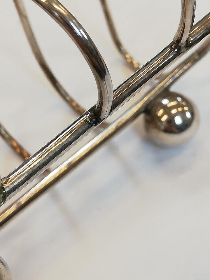 An Edwardian silver four division toast rack, Jones & Crompton, Chester 1906, ogee arches with - Image 4 of 6