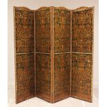 An early 20th century three fold leather room screen, the four panels embossed with a classical