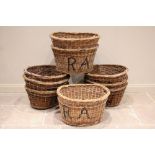 A collection of nine wicker laundry baskets, early 20th century, each of typical oval form, the