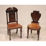 A Regency mahogany shield back hall chair, with carved scroll detail and circular lobed forelegs,