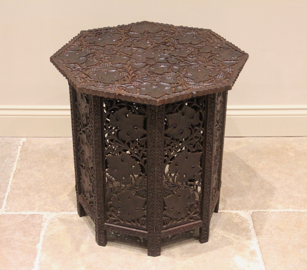 An Anglo Indian hardwood folding octagonal table, early 20th century, the table top carved in relief