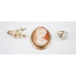 A 9ct gold carved shell cameo brooch, the central oval cameo depicting the profile of a woman, set