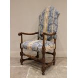 A 17th century style walnut and upholstered open armchair, mid 20th century, the shaped padded