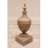 A carved hardwood lamp base, of classical urn form, the removable turned finial above incised