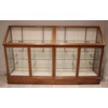 A large Edwardian mahogany haberdashers shop display cabinet, with two hinged sloping glazed doors