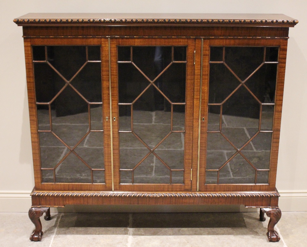 An early 20th century Chippendale revival mahogany glazed bookcase, the rectangular top with a