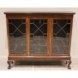 An early 20th century Chippendale revival mahogany glazed bookcase, the rectangular top with a