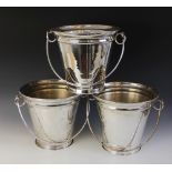 Three large silver plated champagne buckets, each of tapering form with loop handles, each 49cm high