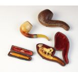 A carved meerschaum pipe, 19th century, modelled as two horses on a naturalistic ground, with
