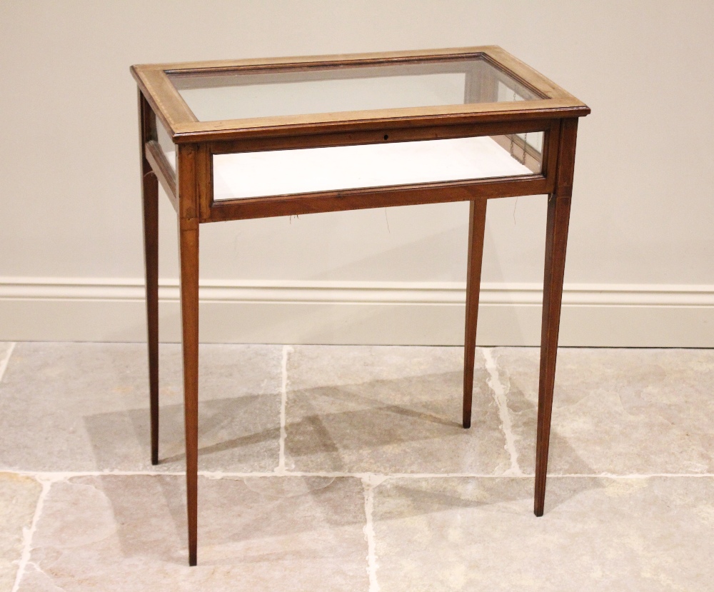 An Edwardian mahogany and satinwood inlaid bijouterie table, the glazed rectangular hinged top