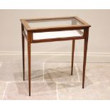 An Edwardian mahogany and satinwood inlaid bijouterie table, the glazed rectangular hinged top