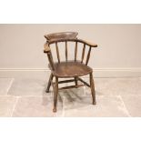 A Victorian elm and beech wood captain?s chair, the horseshoe shaped top rail on tapering spindles