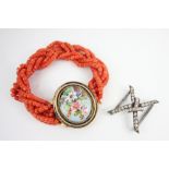 A Victorian bracelet, designed as woven strands of coral beads, the clasp designed as an oval floral