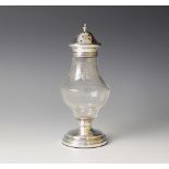 A George V silver mounted glass sugar caster, of baluster form with floral swag decoration, weighted