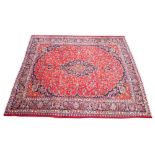 A large Persian hand knotted wool carpet, the central foliate lozenge shaped medallion upon a