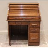 An early 20th century single pedestal oak roll top desk, the tambour sliding front above a single