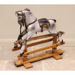 A mid 20th century dappled grey wooden rocking horse, applied with horse hair mane and tail, and