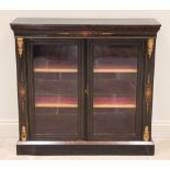 A Victorian ebonised and amboyna pier cabinet, the rectangular top above an amboyna banded frieze