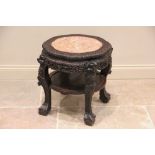 A Chinese hardwood and marble urn stand, late 19th/early 20th century, the circular scalloped top