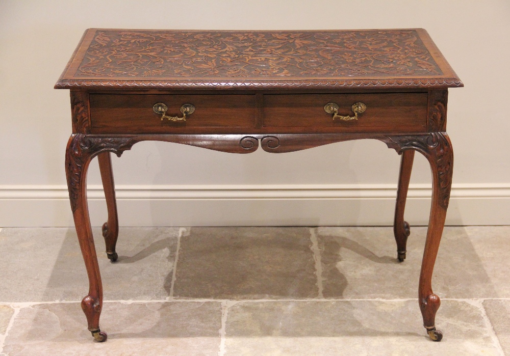 An early 20th century mahogany side table, the rectangular moulded top applied with trailing foliate