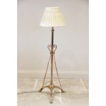 An early 20th century brass telescopic standard lamp, the plain cylindrical adjustable column