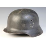 WORLD WAR II INTEREST: A German Heer [Army] helmet (possibly a model M35), with remnants of a Heer