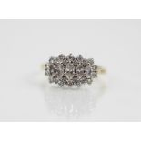 A diamond 18ct gold cluster ring, comprising five graduated marquise cut diamonds with an oval