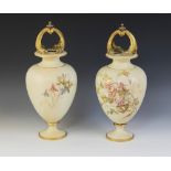 A pair of Royal Worcester blush ivory urns, late 19th century, each of inverted baluster form with