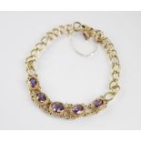 An amethyst set bracelet, comprising five graduated oval amethysts measuring between 7mm