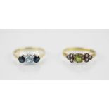 A peridot and seed pearl set 18ct gold ring, comprising a round mixed cut central peridot, flanked