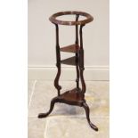 A 19th century mahogany jug and bowl stand, the moulded bowl aperture raised upon three uprights,