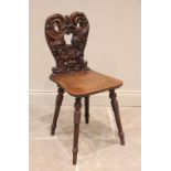 A late 19th century Bavarian carved oak Fratzen Stuhle (grimacing chair) or hall chair, the shield