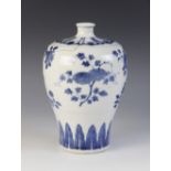 A Chinese porcelain blue and white vase, 18th century, of meiping form and decorated with peach