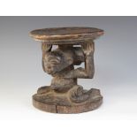 A Luba Tribe caryatid stool, Democratic Republic of the Congo, modelled as a circular platform