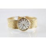 A lady's vintage Zenith 9ct gold wristwatch, the round cream toned dial with baton markers, plain