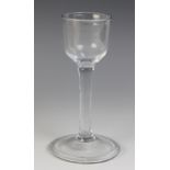 A ogee bowl wine or cordial glass, on plain stem terminating in folded conical foot, unground
