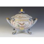 A Portuguese faience tureen and cover, polychrome decorated with a bird and foliage, of