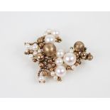 A 1970's 9ct gold pearl set cluster brooch, comprising graduated gold spheres of plain polished