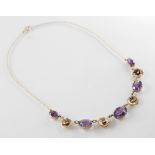 A 9ct gold amethyst set collarette, comprising five graduated oval amethysts measuring between